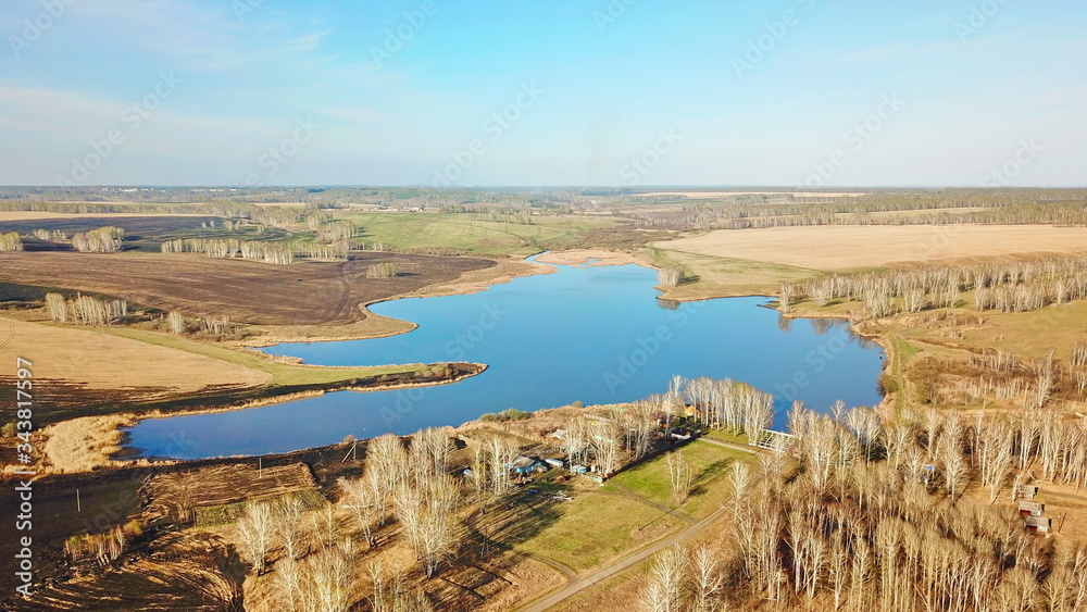 Bird's eye view of a lake in Autumn shot by drone