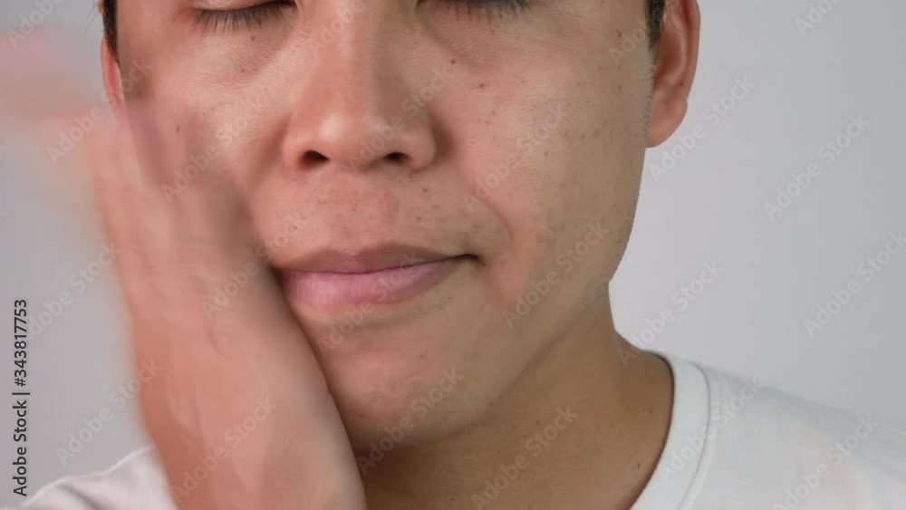Close-up face of a sleepy and yawned young man on white background. Close-up face of a sleepy and yawned young man on white background.