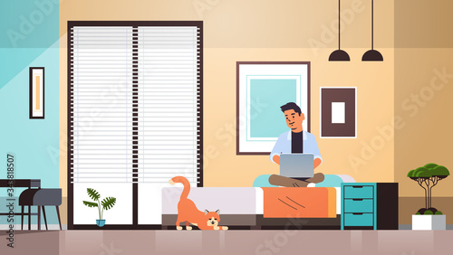 man freelancer using laptop working at home during coronavirus quarantine self-isolation social distancing concept modern living room interior horizontal full length vector illustration