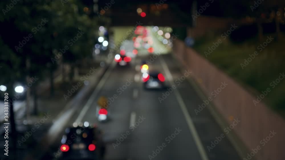 Blurry Night highway traffic bokeh in dark blurry background at night. Defocused colorful bokeh shine from car lights in highway traffic jam on city street. Abstract concept Blurry Night highway traffic bokeh in dark blurry background at night. Defocused colorful bokeh shine from car lights in highway traffic jam on city street. Abstract concept