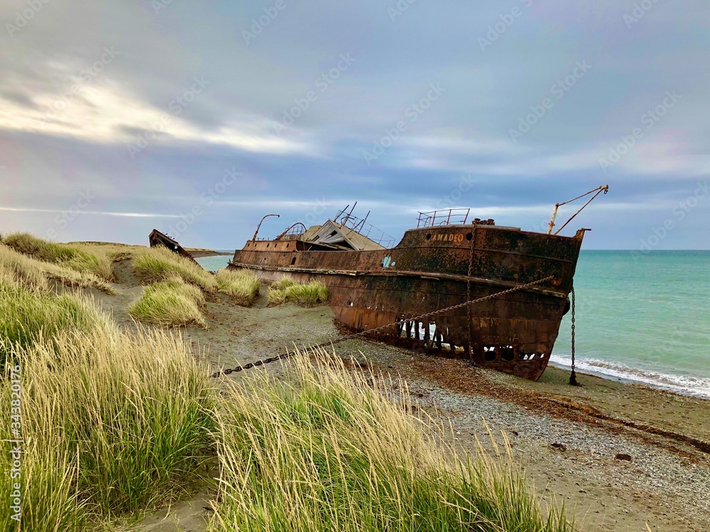 old rusty shipwreck on shore