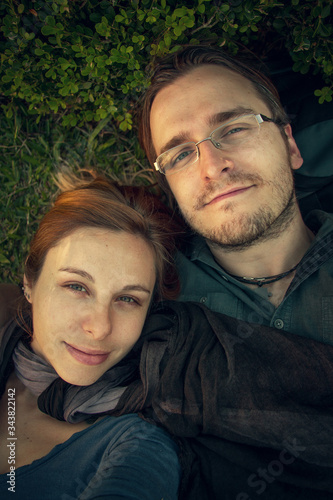 Happy young couple posing for selfie on a grass background