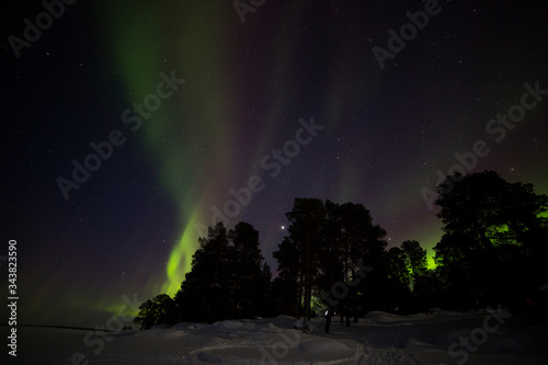 Northern lights in Inari Lake, Lapland, Finland © Alberto Gonzalez 
