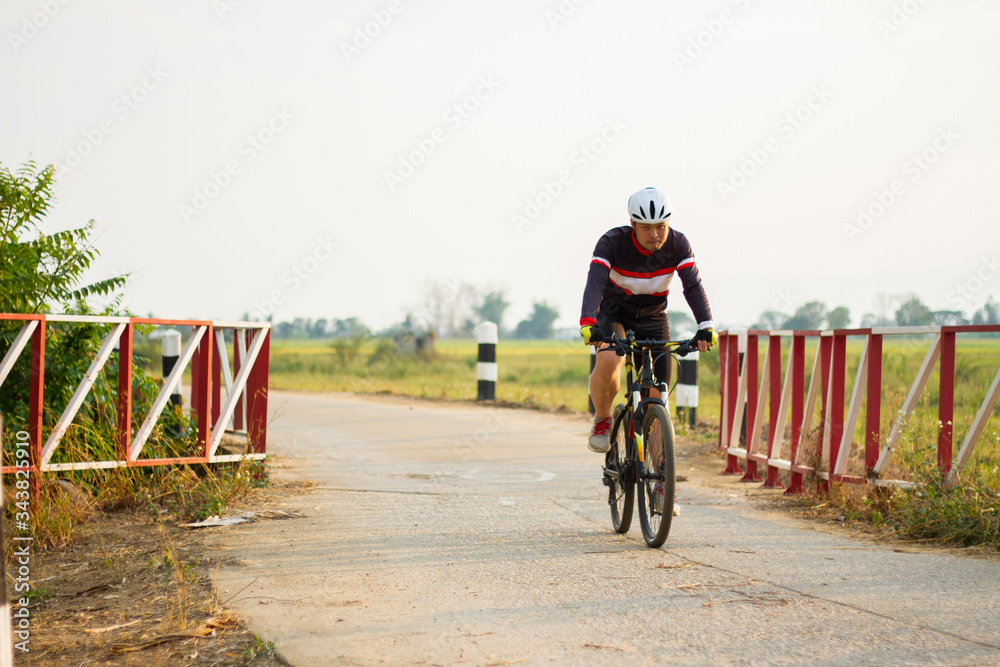 Fototapeta premium Asian men ride bicycles for exercise.