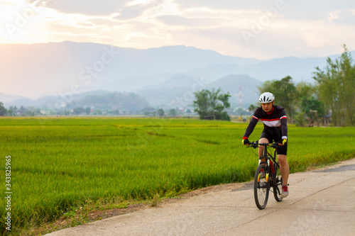 Asian men ride on a mountain bike. Sport and active life concept.