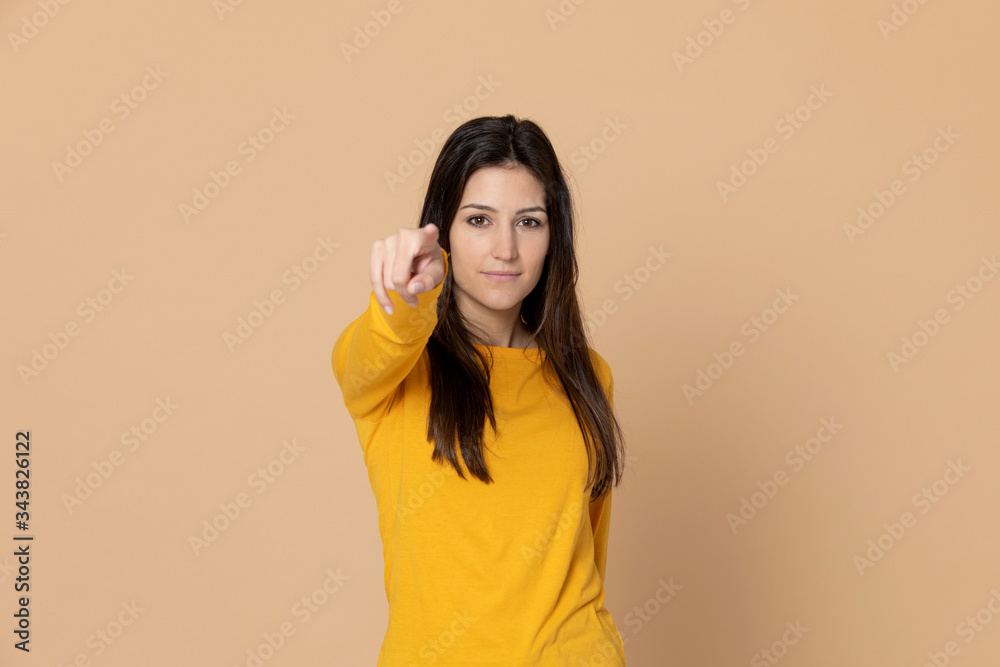 Brunette young woman wearing a yellow T-shirt Brunette young woman wearing a yellow T-shirt