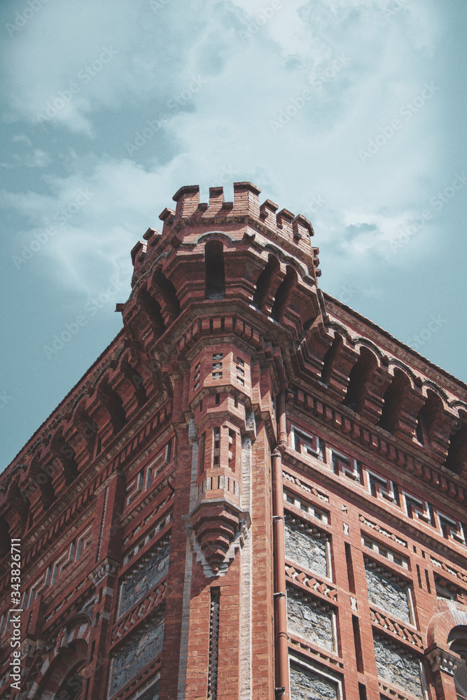 old brick building with blue sky