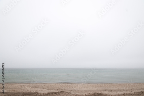 Minimalist shore and waves on a foggy day, Scandinavia