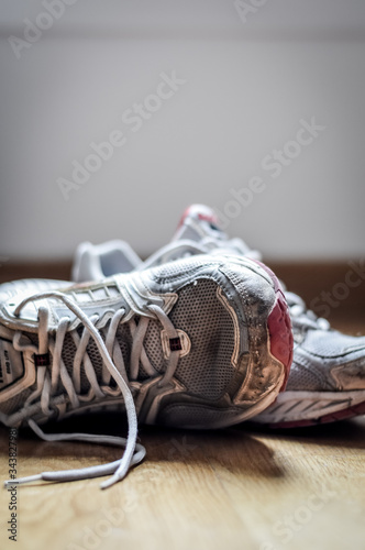Old dirty sneakers close up, selective focus, desaturated colors.