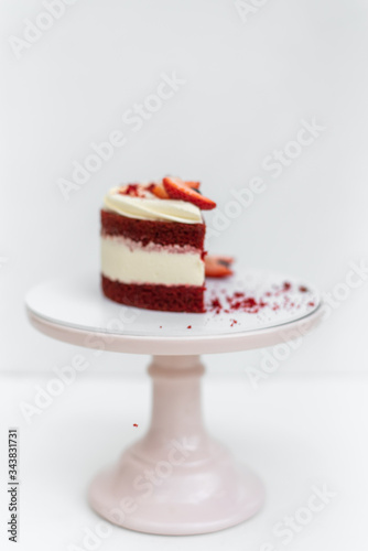 Delicious homemade red velvet cake with fresh berries on white background
