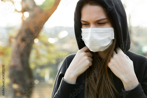 Woman wearing face mask during coronavirus outbreak. Protection against virus infection exhaust and industrial emissions