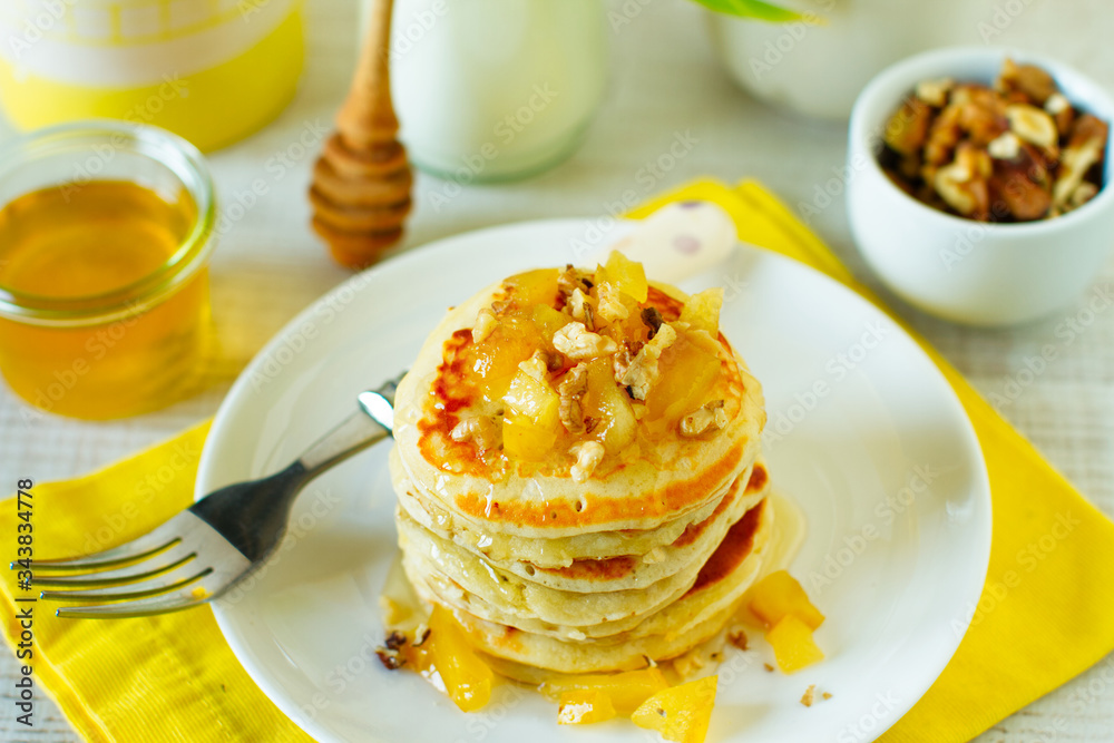 Homemade rustic pancakes stack with baked apples and walnuts Homemade rustic pancakes stack with baked apples and walnuts