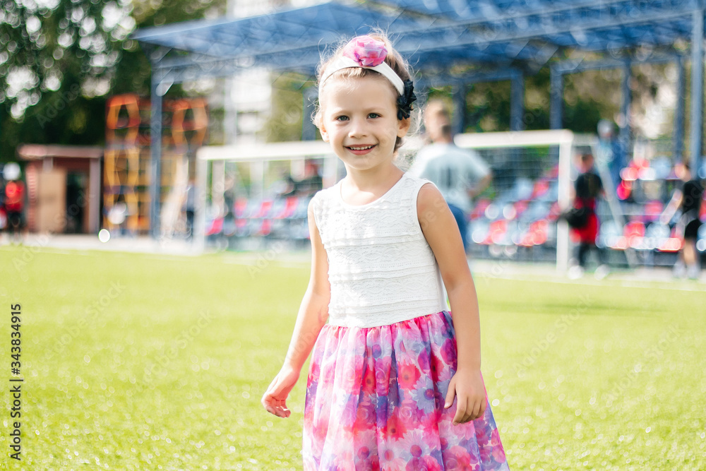 laughing girl playing and running with hands on the field and grass laughing girl playing and running with hands on the field and grass