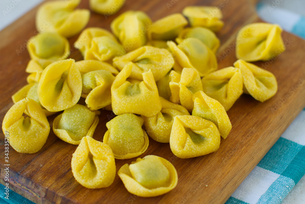 Fresh spinach and ricotta tortellini on a rustic table
Fresh spinach and ricotta tortellini on a rustic table