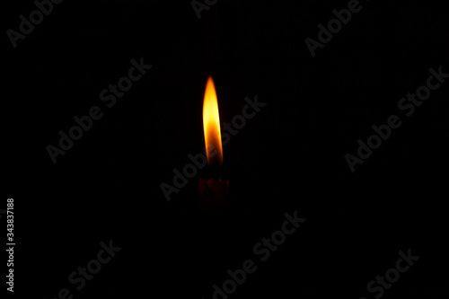 Burning candle fire on a black background
