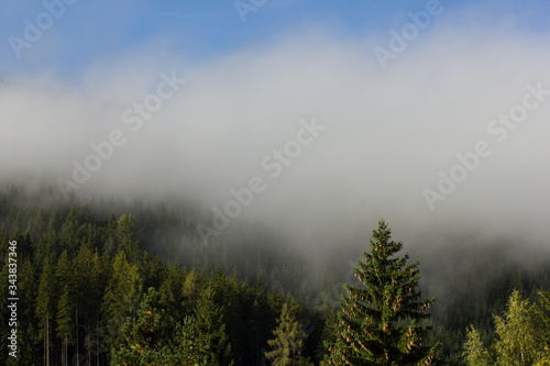 Beautiful mountain slope with clearing mist in the morning