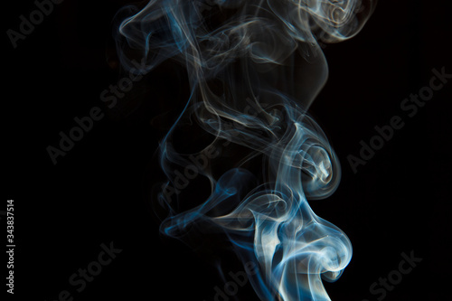 Smoke from an extinct candle on a black background