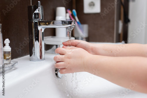 hands wash with soap in the sink. Hand washing with soap and water to prevent coronavirus and hygiene to stop the spread of coronavirus. the child washes his hands