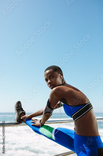 Woman runner stretching outdoors