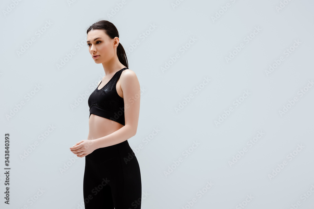 sportive woman in sportswear standing isolated on white sportive woman in sportswear standing isolated on white