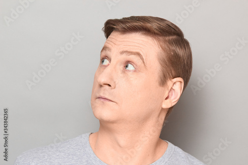 Portrait of blond mature man with surprised perplexed expression