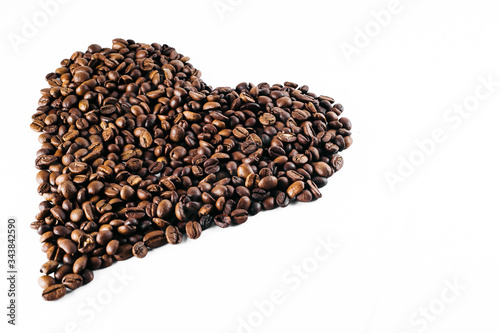 Coffee beans laid out on a white background with a basket