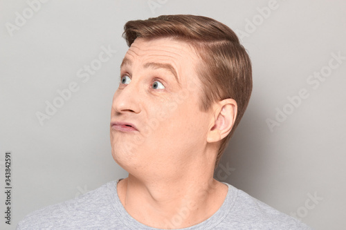 Portrait of blond mature man with fool goofy perplexed expression