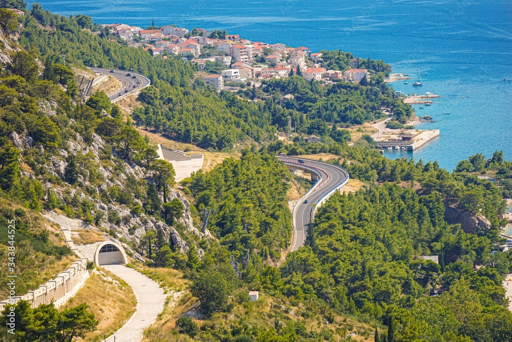 Mountain road along the coast of the Adriatic Sea, the city of Omis. View from the walls of an old pirate fortress