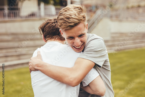 Εκτύπωση καμβά High school students greeting each other with a hug