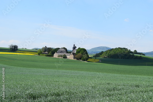 Eifellandschaft mit Pilgerkirche 'Fraukirch' und winziger Siedlung photo