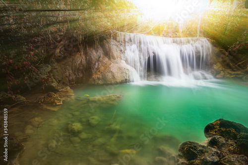 Waterfall in autumn forest with light ray  tyndall lighting effect  Huay Mae Kamin Waterfall   Beautiful waterfall in rainforest at Kanchanaburi province  Thailand