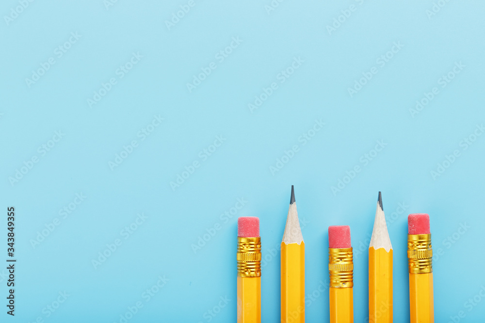 Orange pencils with an eraser on a blue background. Orange pencils with an eraser on a blue background.