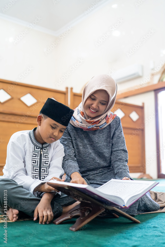 kid learning to read quran with muslim teacher or ustad kid learning to read quran with muslim teacher or ustad
