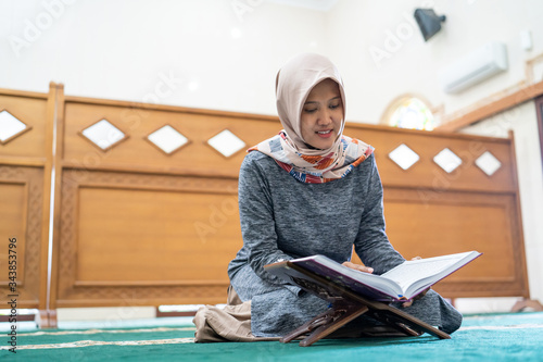 beautiful asian woman read quran in the mosque