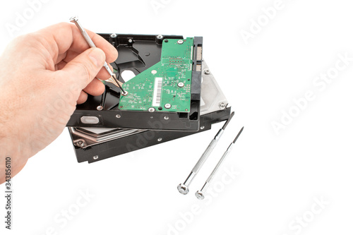 The abstract image of the technician repairing inside of hard disk drive by screwdriver. the concept of data, hardware, technician and technology, copy space