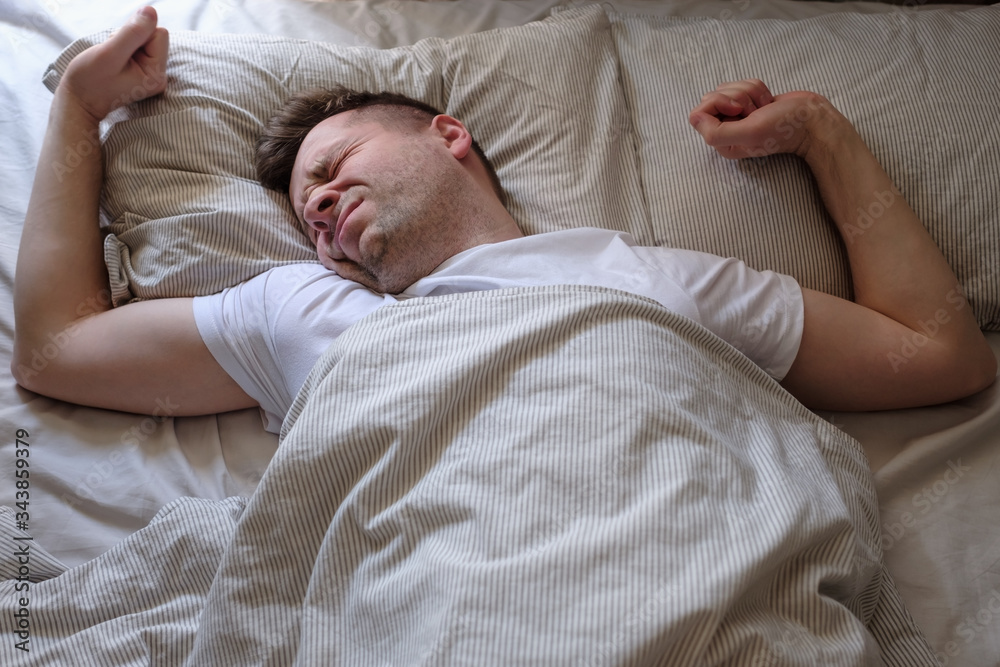 Young caucasian man trying to wake up Young caucasian man trying to wake up