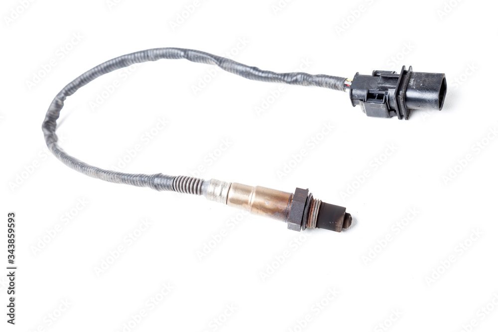 Lambda probe - oxygen sensor device designed to record tamount of remaining oxygen in the exhaust gas of car engine is located in exhaust system. Metal spare part for replacement to repair in workshop