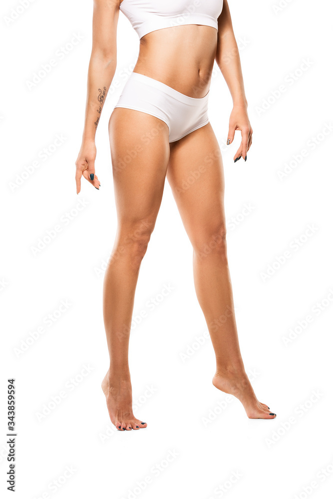 Beautiful female legs and belly isolated on white background. Beauty, cosmetics, spa, depilation, treatment and fitness concept. Fit and sportive, sensual body with well-kept skin in underwear. Beautiful female legs and belly isolated on white background. Beauty, cosmetics, spa, depilation, treatment and fitness concept. Fit and sportive, sensual body with well-kept skin in underwear.