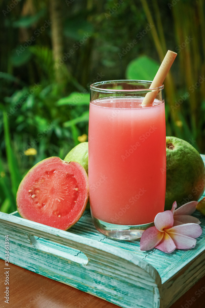 Guava smoothie in glass with bamboo drinking straw Guava smoothie in glass with bamboo drinking straw