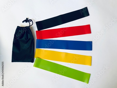 Set of colorful latex rubber bands for fitness on a white background.  sports concept.  fitness trend for home workouts. top view, flat lay, copy space. 