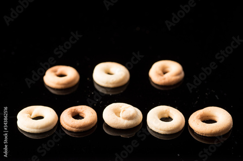 Spanish artisan donut, with flour, sugar, butter, eggs. Photo on methacrylate with reflection. photo