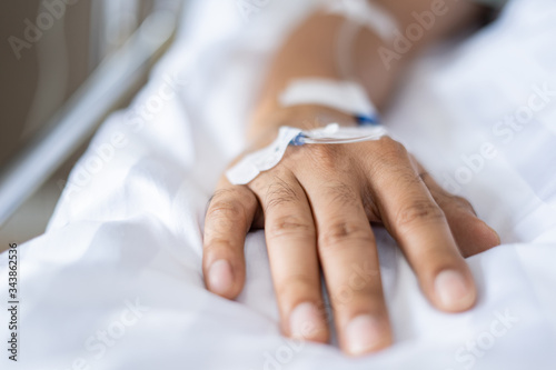 Needle On Patient covid 19 or coronavirus Hand lying in hospital room The Hospital