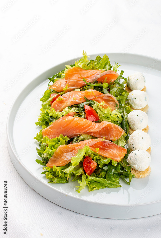 Salmon salad with cheese balls on a white plate Salmon salad with cheese balls on a white plate