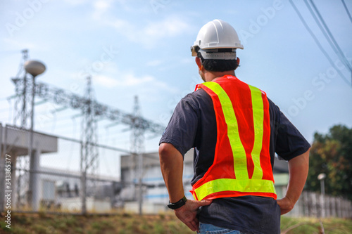 Engineering is checking progress on building construction of power plants,Young engineer standing at the substation.