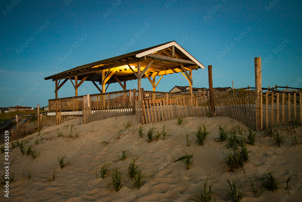Night lights still illuminate a pavilion before dawn at the Jersey shore