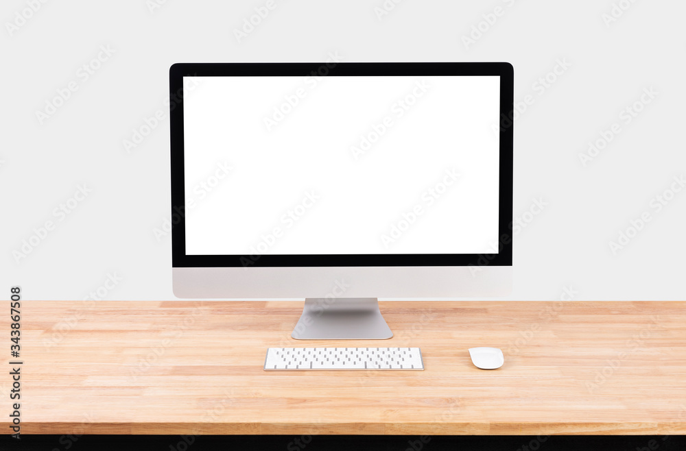 Mockup Blank screen desktop computer on wood table and white wall background. Mockup Blank screen desktop computer on wood table and white wall background.