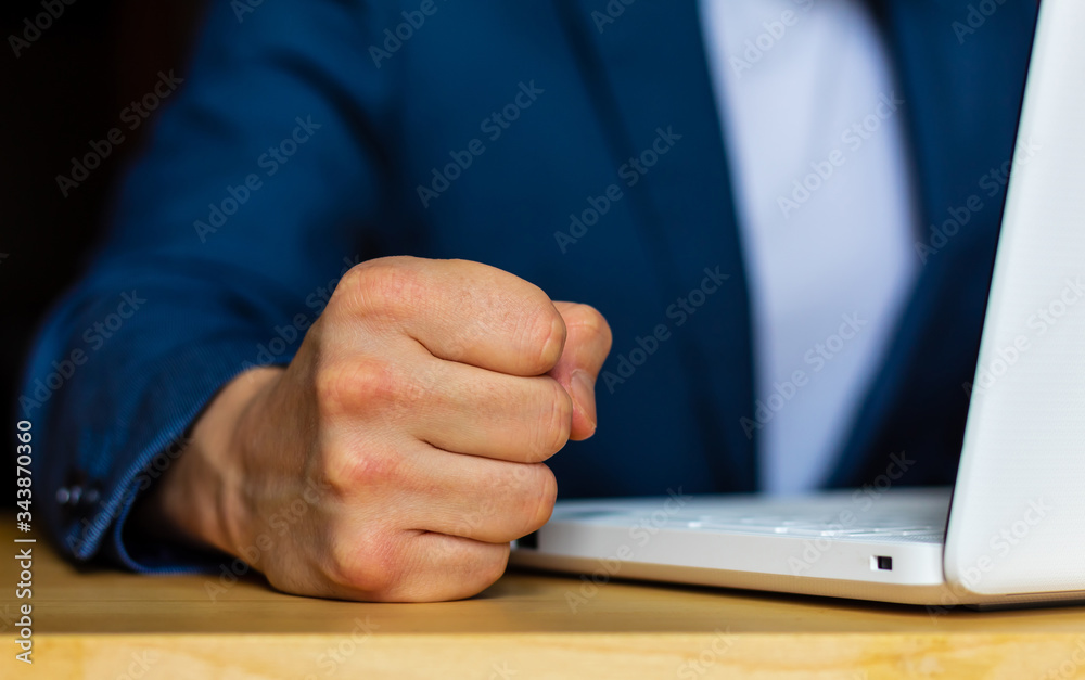 Φωτογραφία Close-up of the hands of a well-dressed man in a blue suit and a white shirt hitting the table