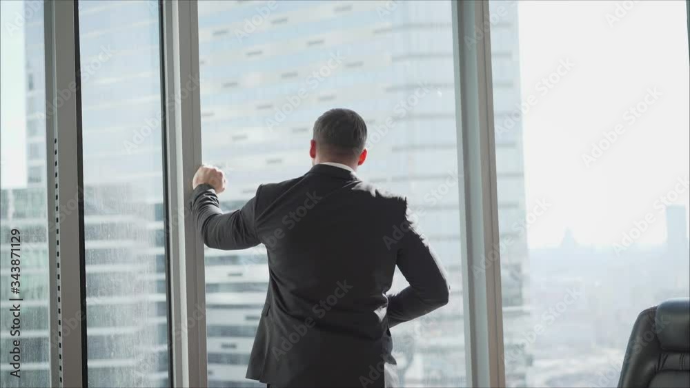 Single adult business man waiting for meeting to begin in Board room. A businessman at the end of the day gets up and goes home. A businessman Single adult business man waiting for meeting to begin in Board room. A businessman at the end of the day gets up and goes home. A businessman
