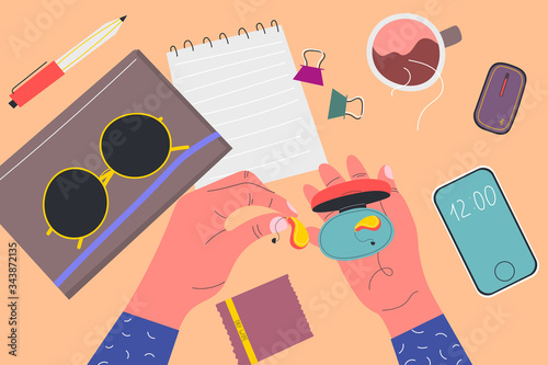 View from above. Men's holds box from under the hearing aid. Notebooks, sunglasses, phone, wipe, pen, clamps, cup of tea, device. Colorful vector illustration in flat cartoon style.