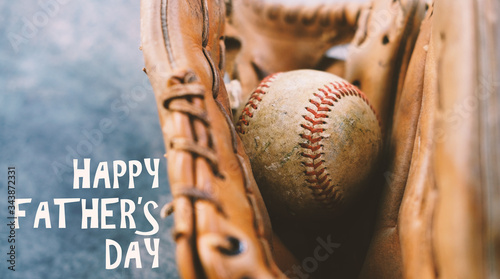 Baseball in ball glove with happy fathers day text on background.